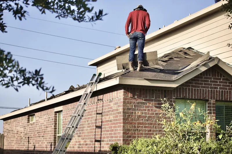 Professional roofer working on a residential roof in Riverside Village of Church Creek